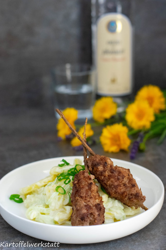 Griechischer Kartoffelsalat mit Hackfleischspieß am Rosmarinzweig